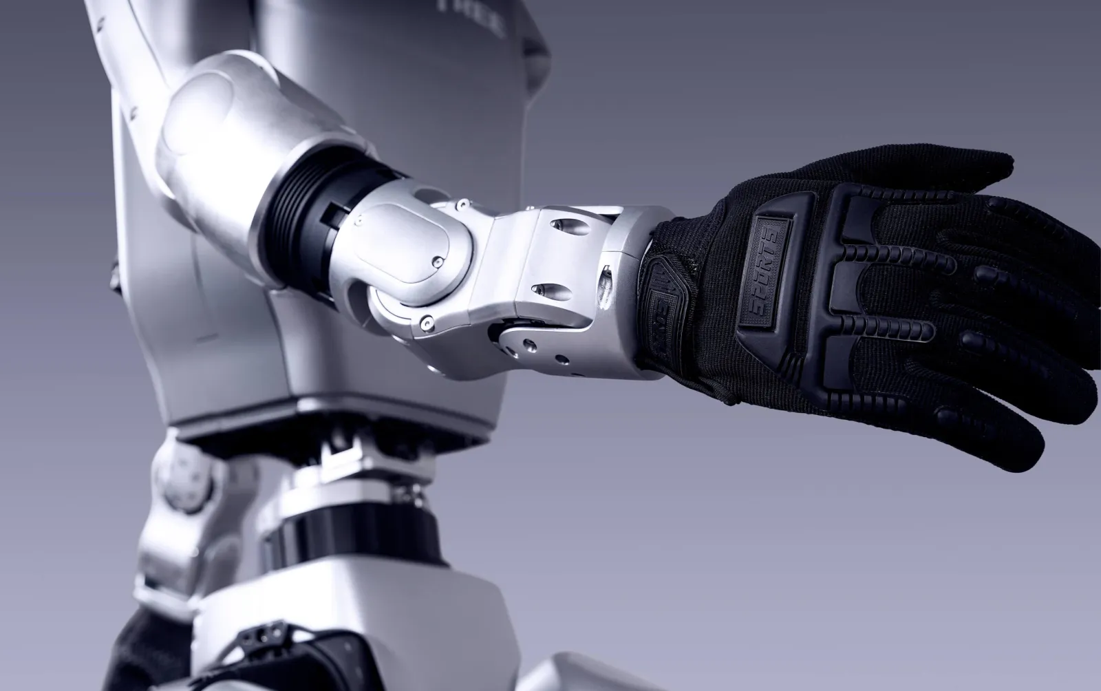 Close-up of the G1 robotic arm wearing a tactical glove, reaching forward